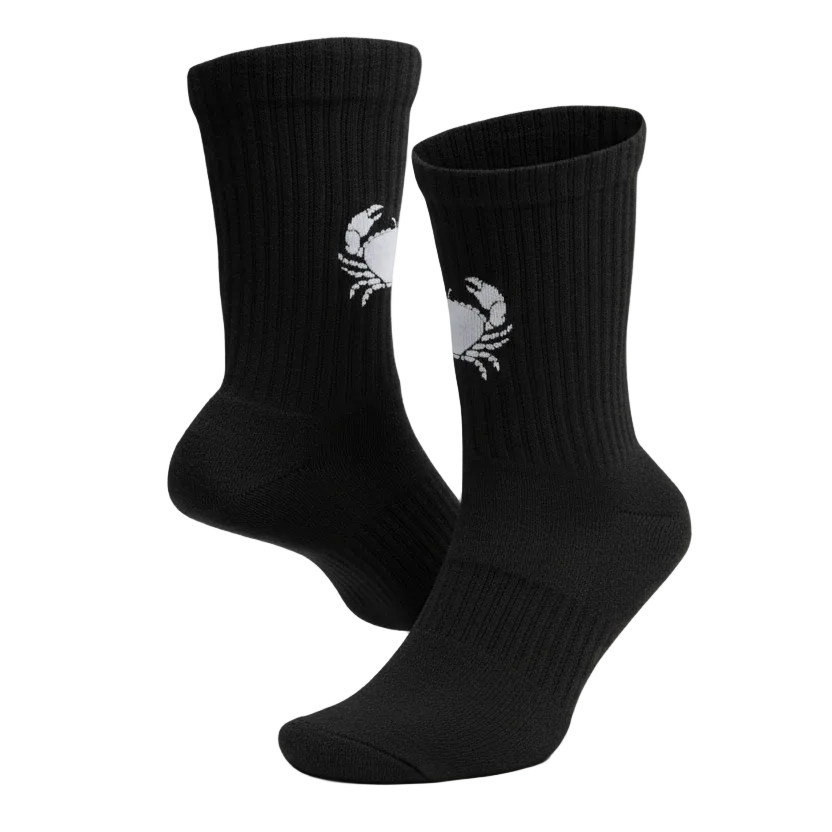 Black socks with a crab design on a light gray background